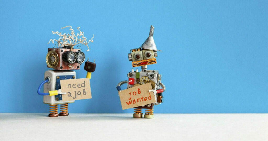 Job search concept. Two robots wants to get a job. Smiley unemployed robotic characters with a cardboard sign and handwritten text Need a job and Job Wanted. Blue gray background, copy space for text